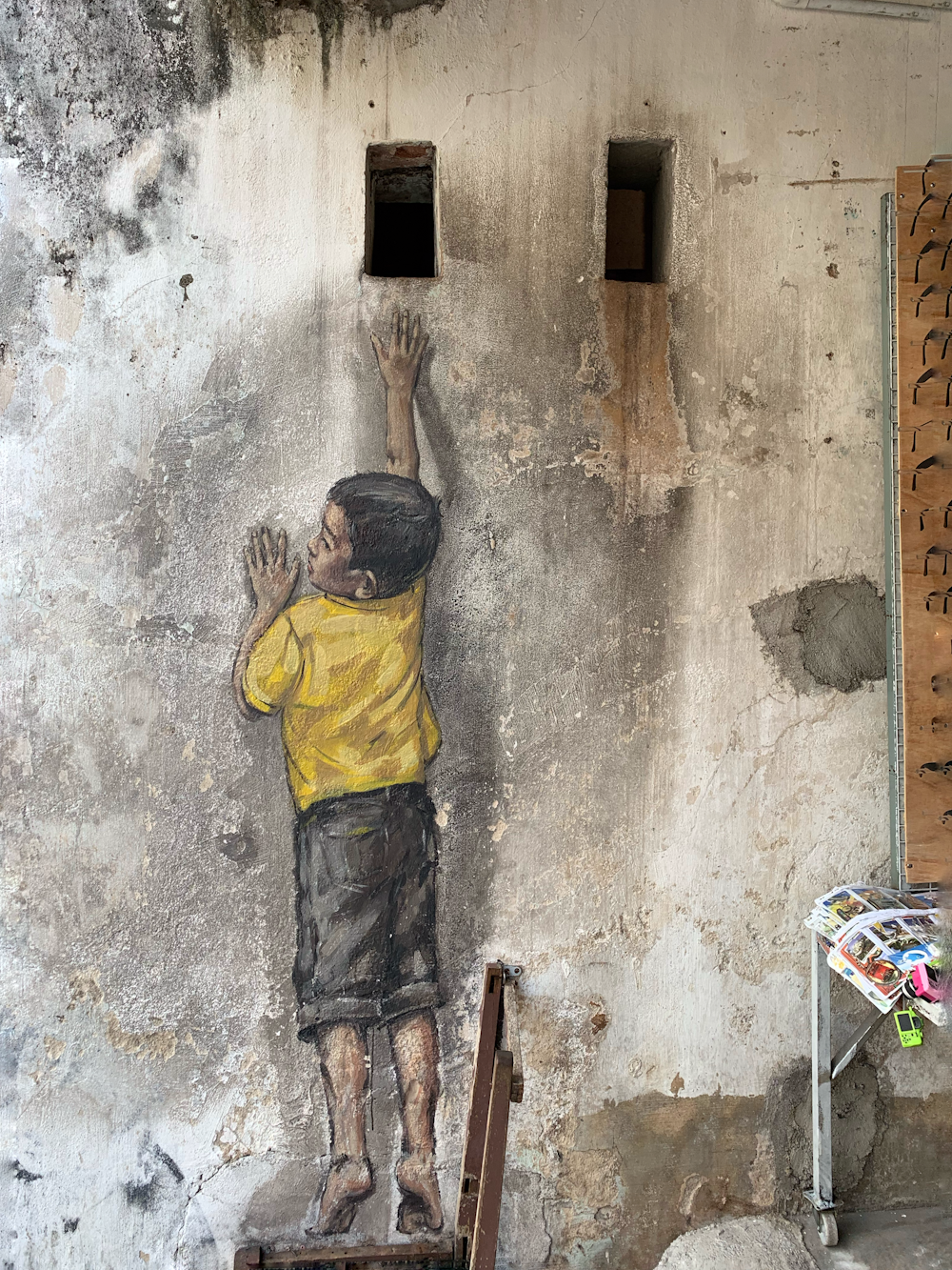 boy in yellow shirt painting