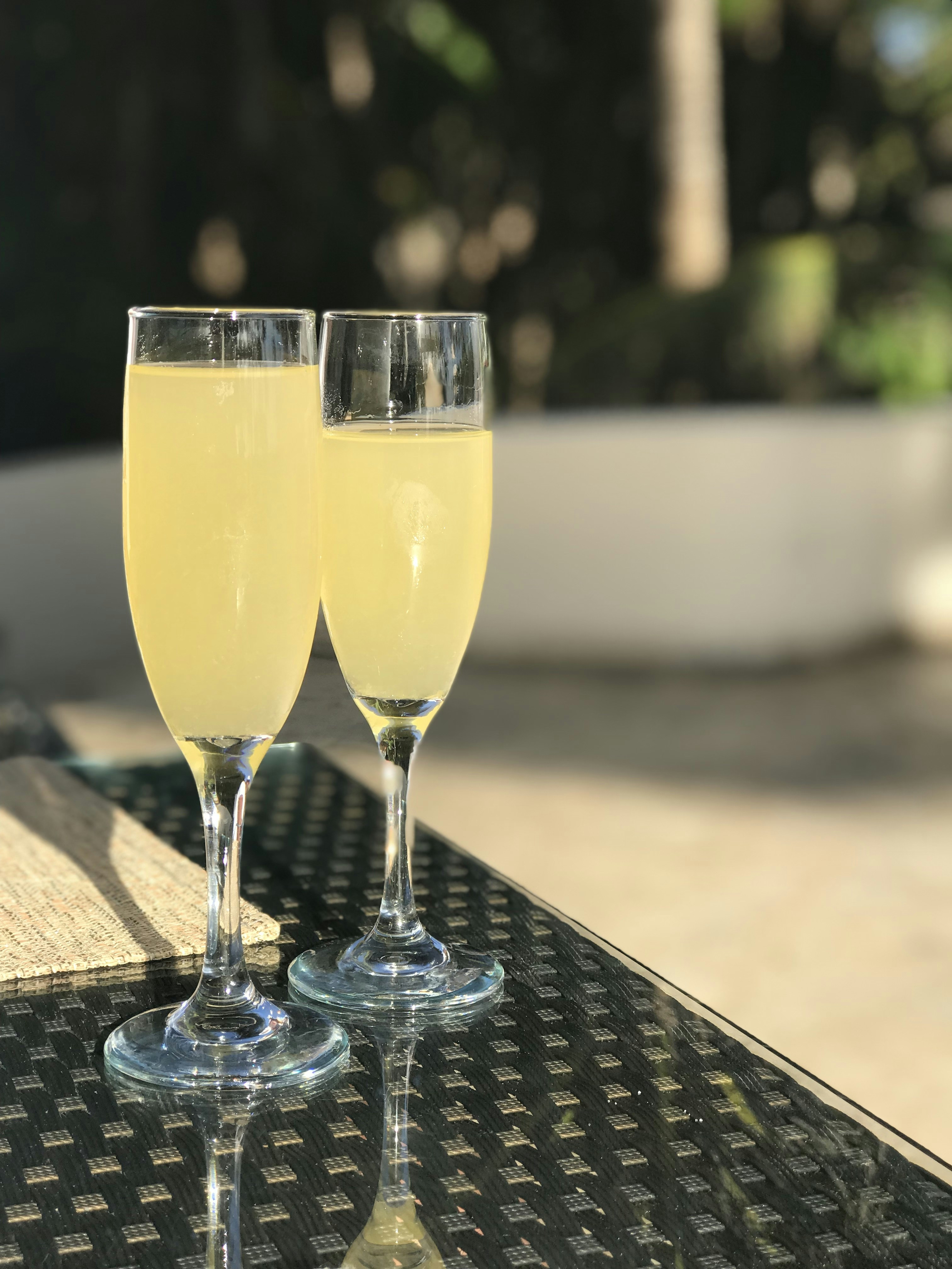 selective focus photography of two champagne flute glasses