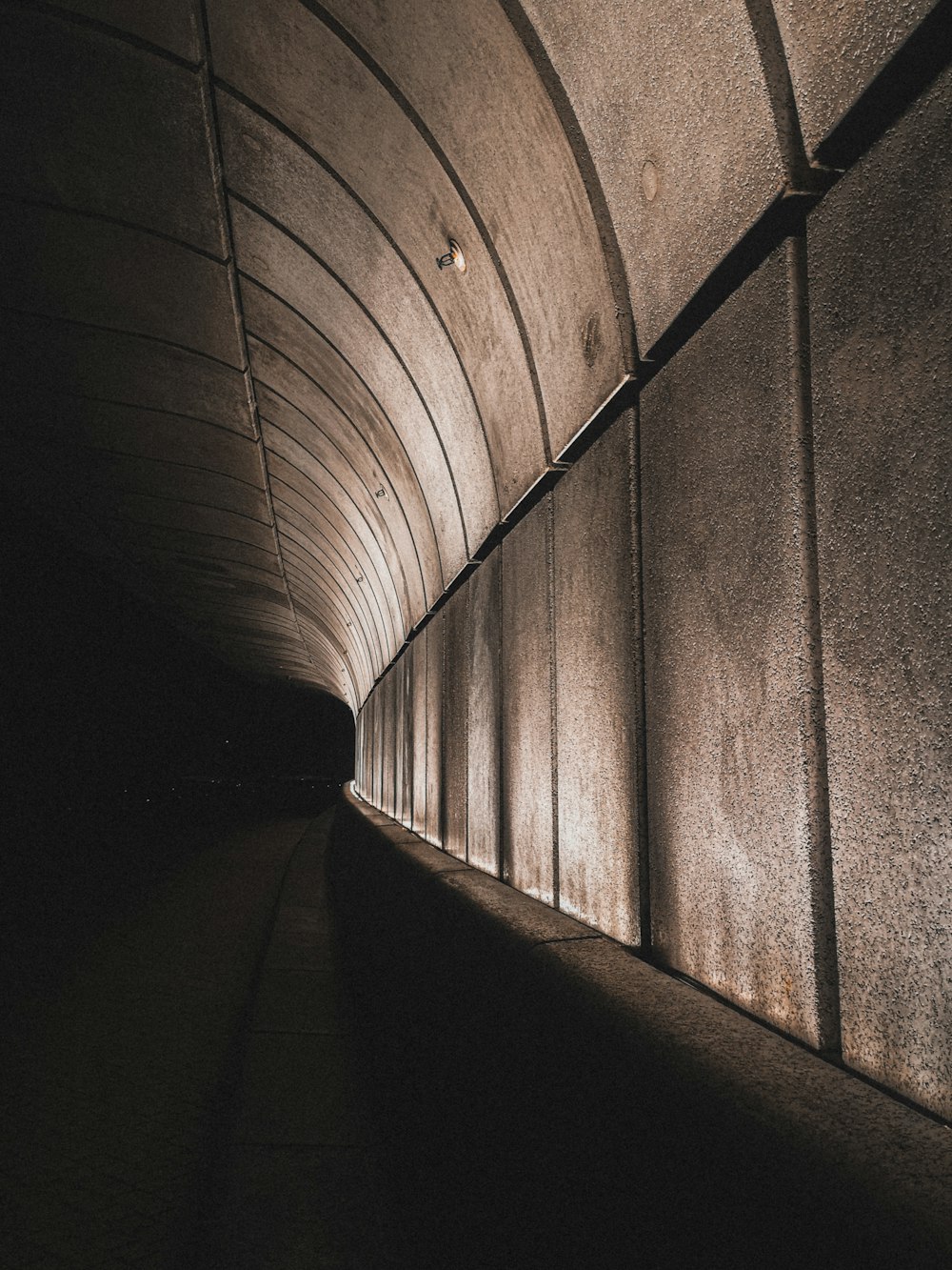 a long tunnel with a light at the end