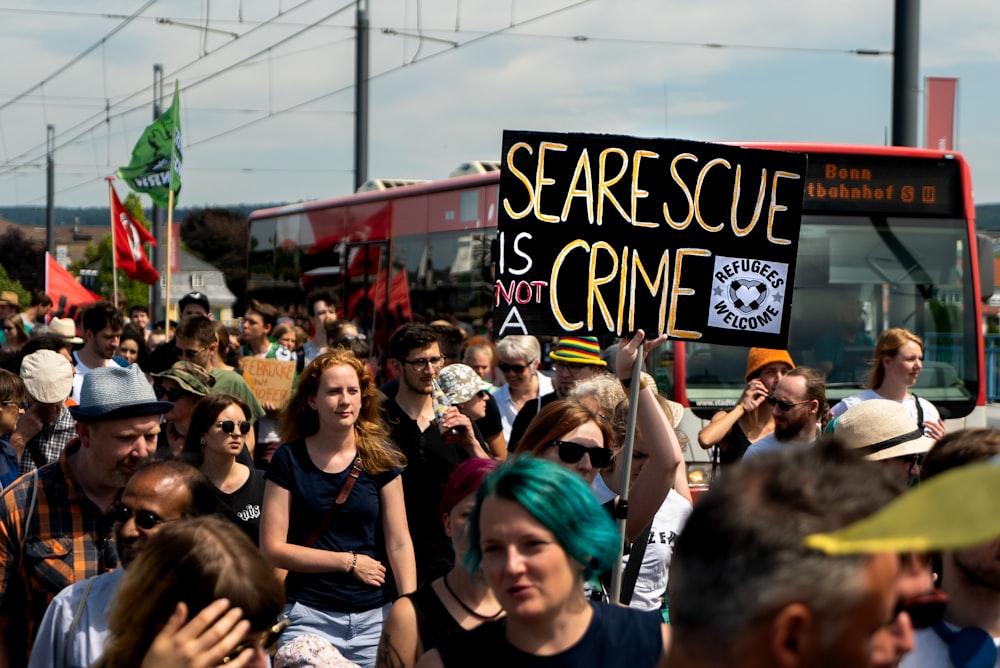 a crowd of people holding signs in the street