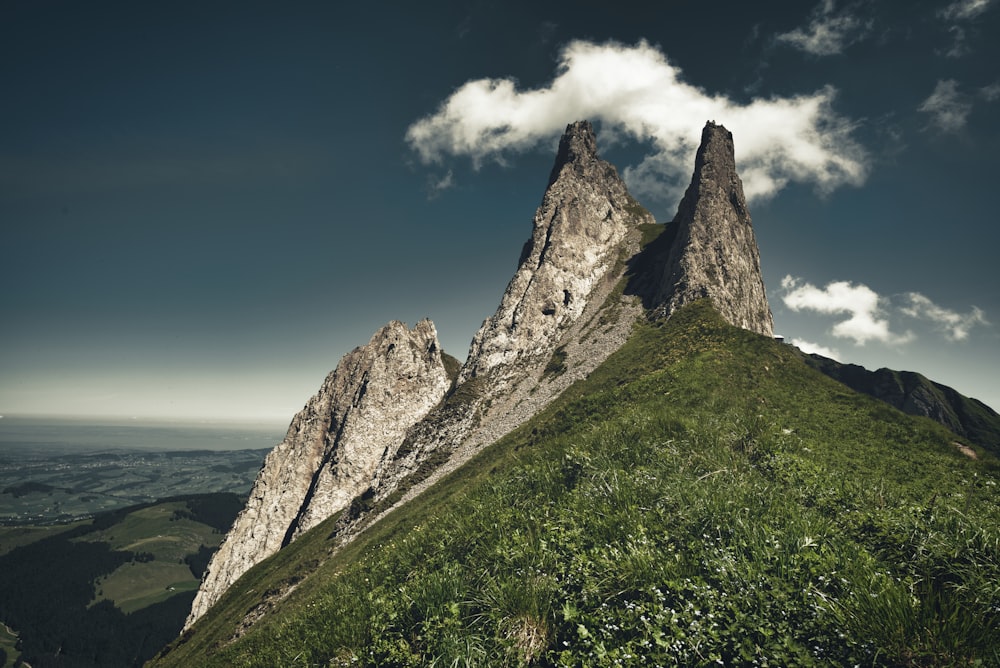 mountain under white clouds and blue sky