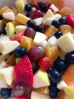 Colorful assortment of fresh fruits arranged neatly on a tray.