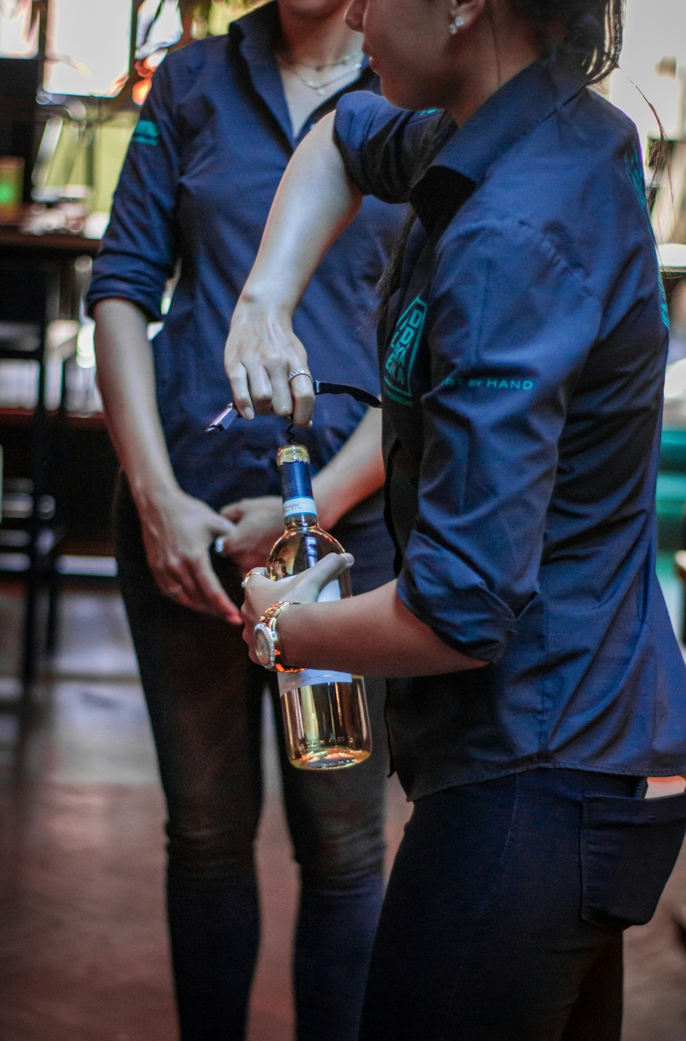 unknown person holding clear glass bottle