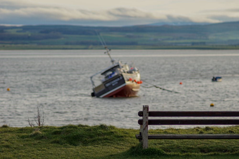 boat on body of water near wooden bench