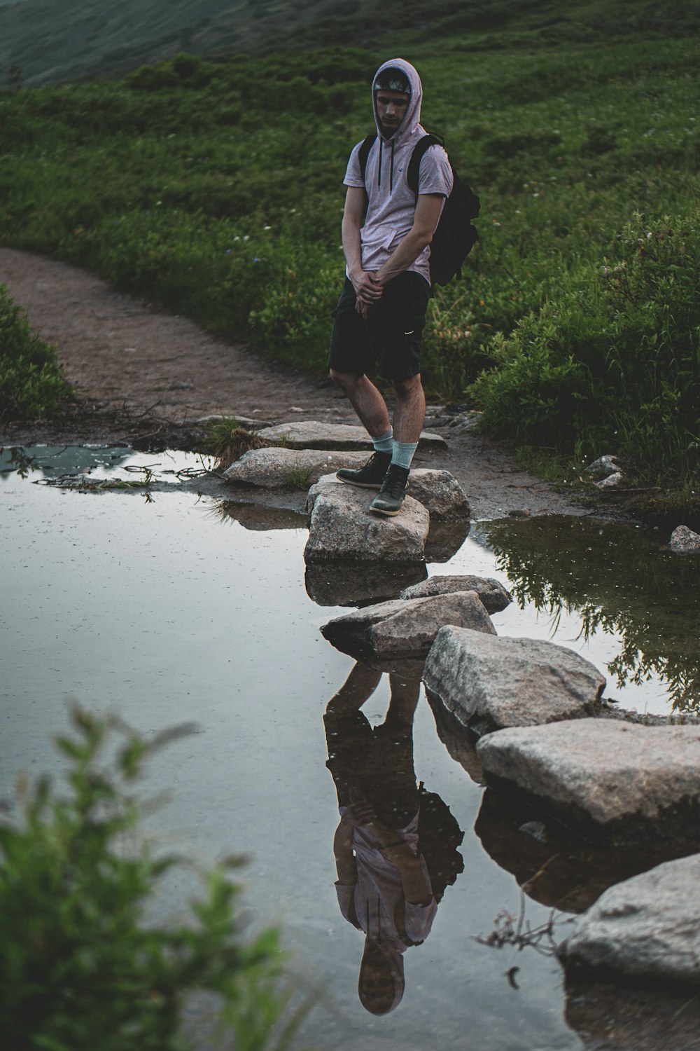 man standing on roc