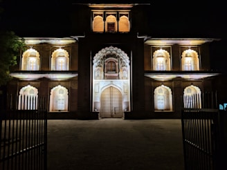 Night view of a well-lit architectural structure highlighting textures.