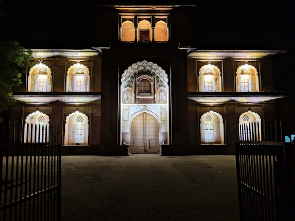 Night view of a well-lit architectural structure highlighting textures.