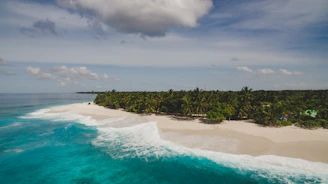 A scenic view of a pristine Lombok beach with turquoise waters and white sand.