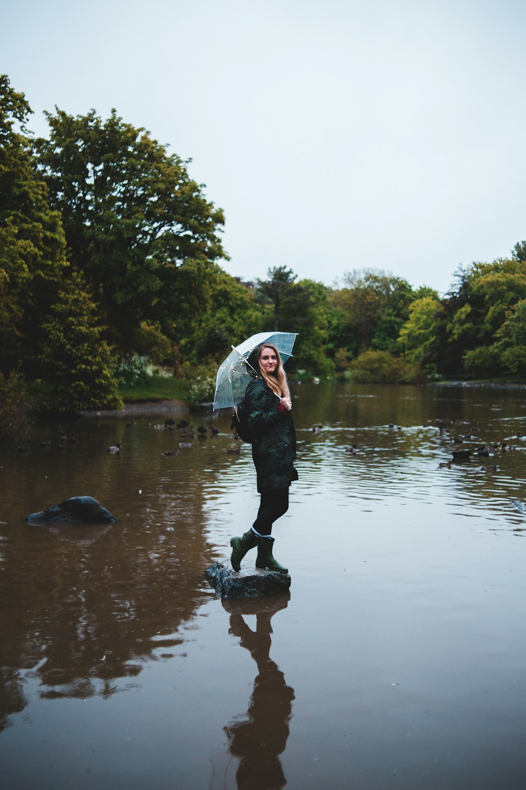 woman with umbrella under white sky