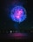 A vibrant drone light show illuminating the night sky over a Caribbean beach.
