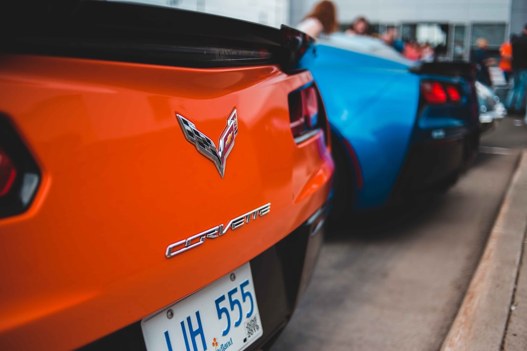 shallow focus photo of red Corvette car