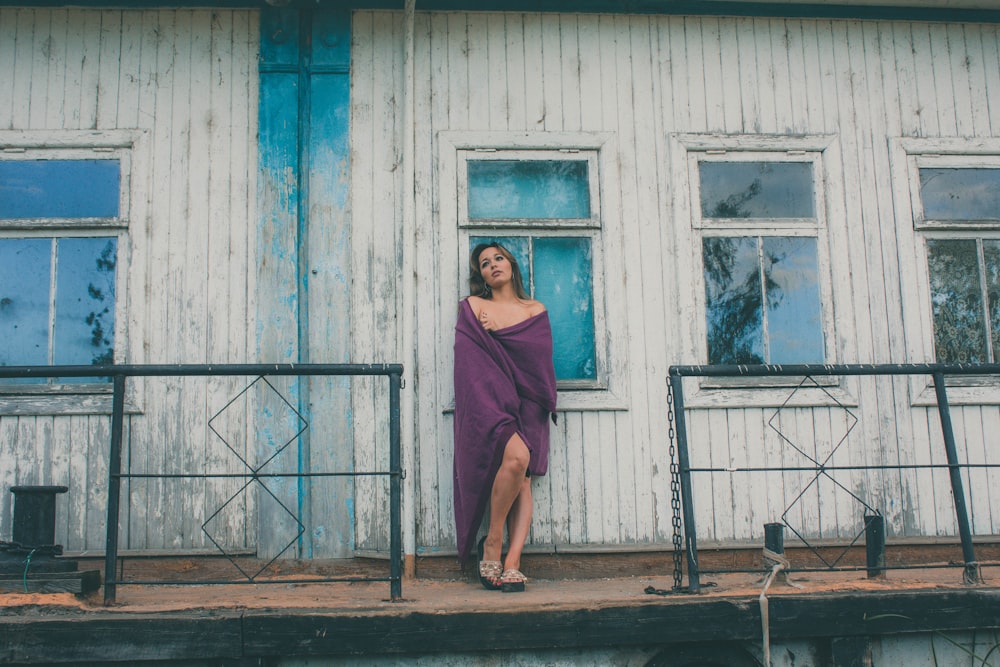 woman covering purple textile on body