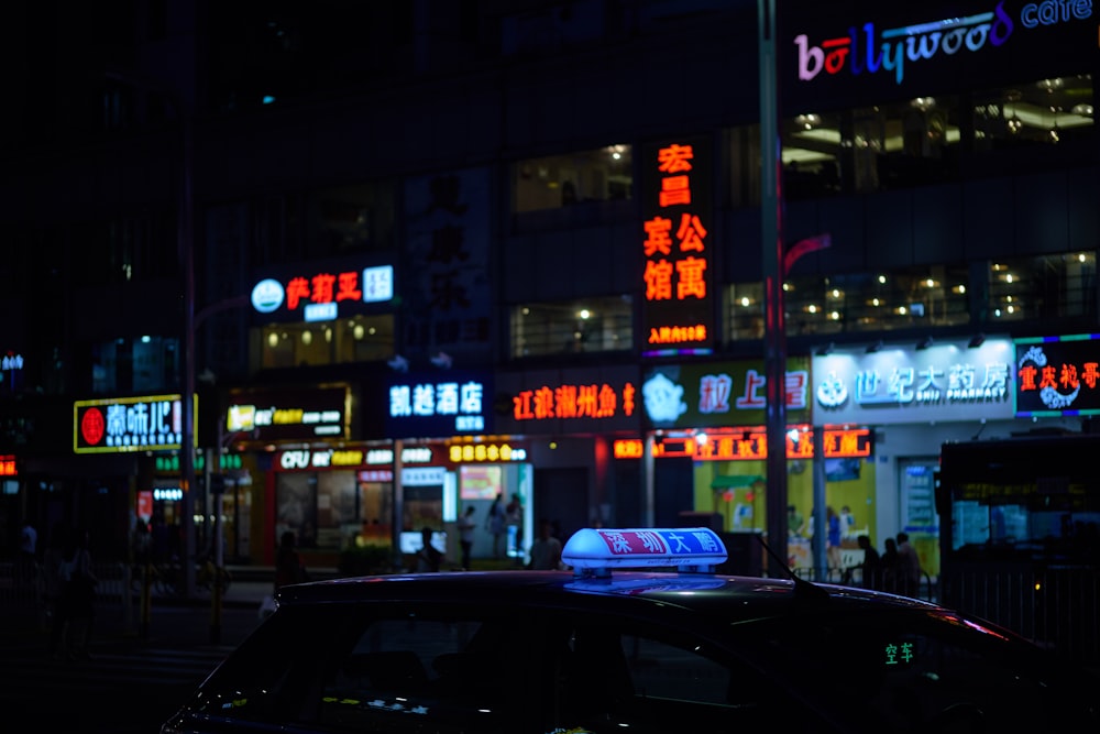 taxi on road beside stores