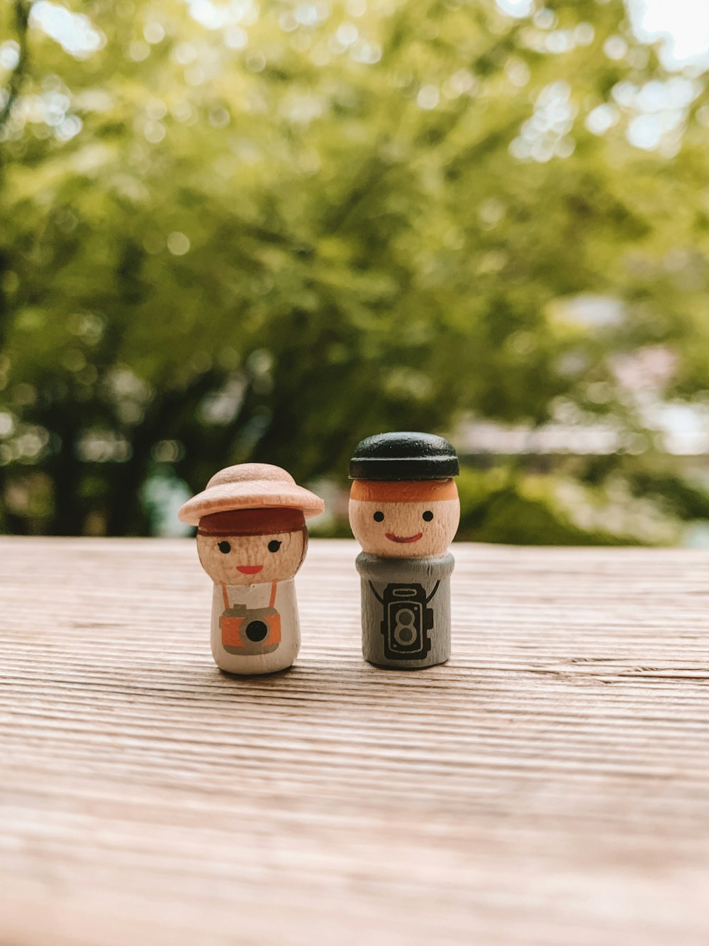 two brown and black plastic toys on brown surface