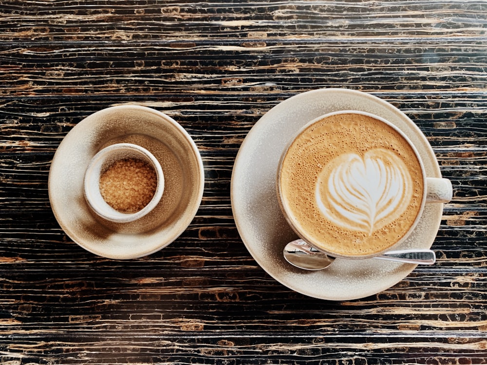 two cups of coffee on a wooden table