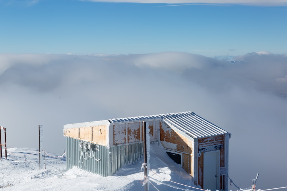 white and brown house covered with snow on mountain