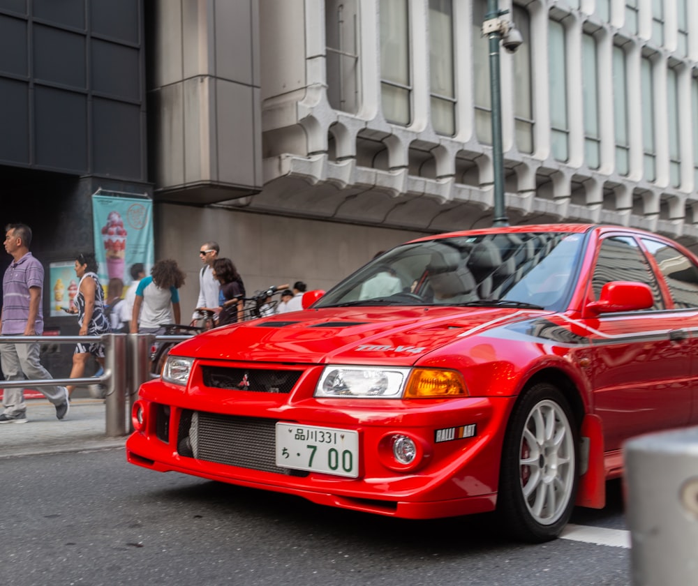 red Mitsubishi vehicle on road