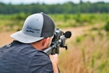 A competitive shooter aiming down the scope at a target.