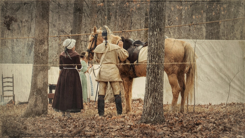 man and woman standing near horse