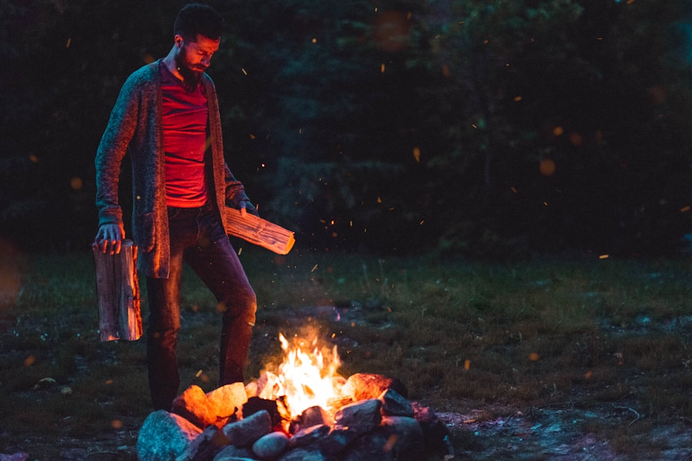 man standing near bonfire