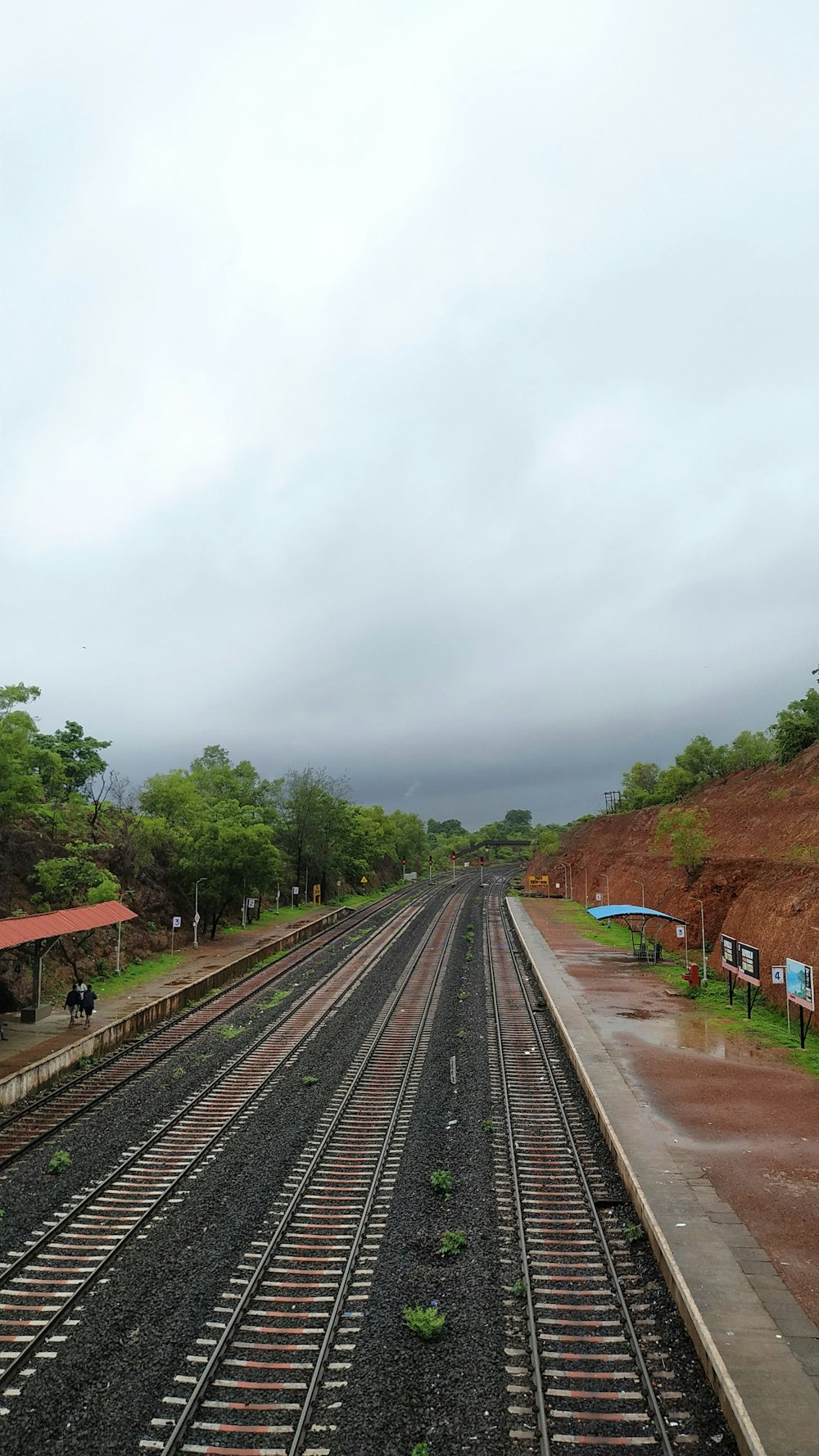 aerial photo of train track under cloudy sky