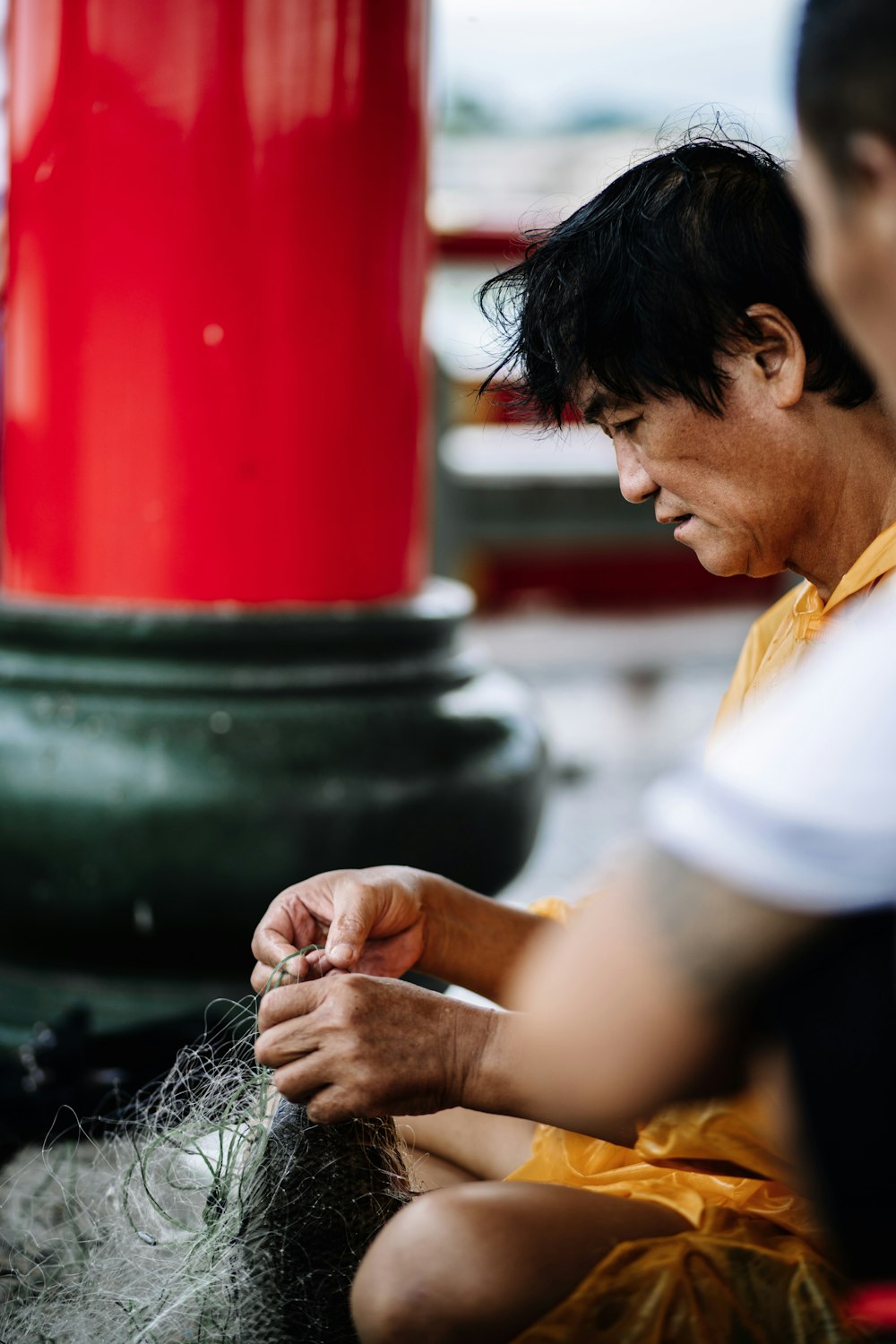 man fixing fish net