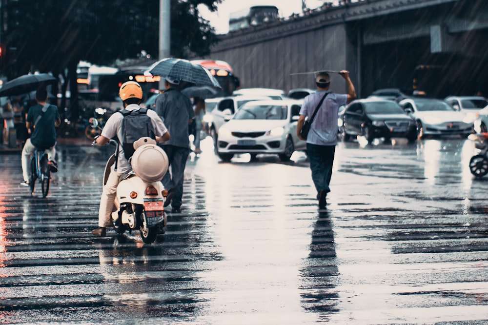 people and cars on road