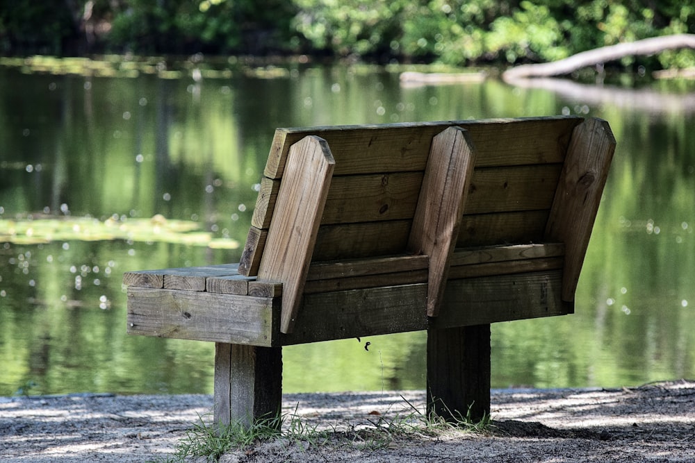 brown wooden bench near body of water