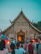 A serene temple backdrop with tourists savoring local street food nearby.