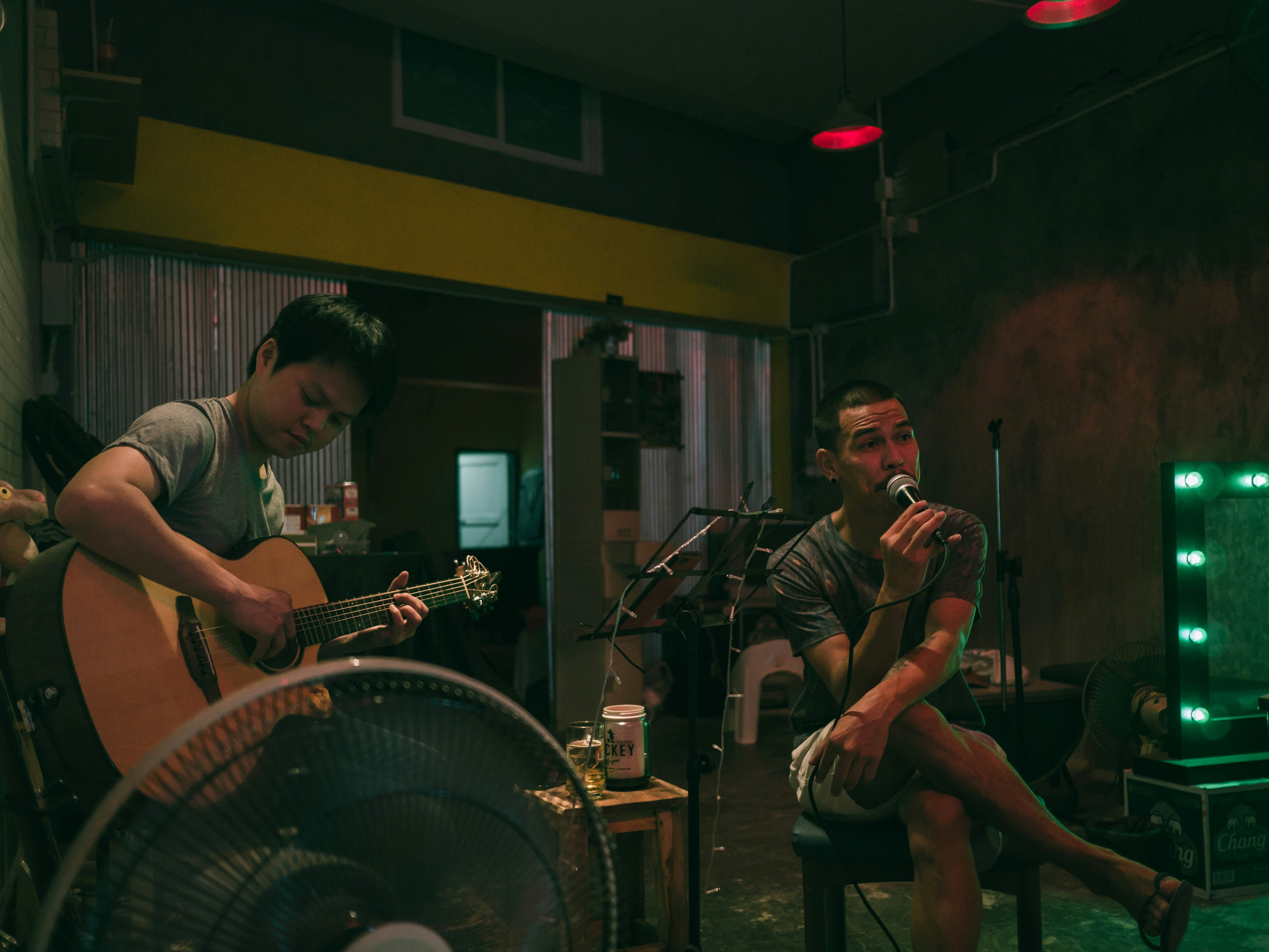 man singing beside man playing guitar