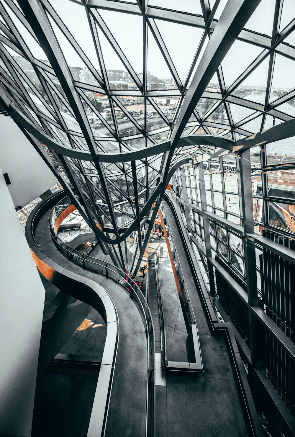 grayscale photo of building with clear ceiling