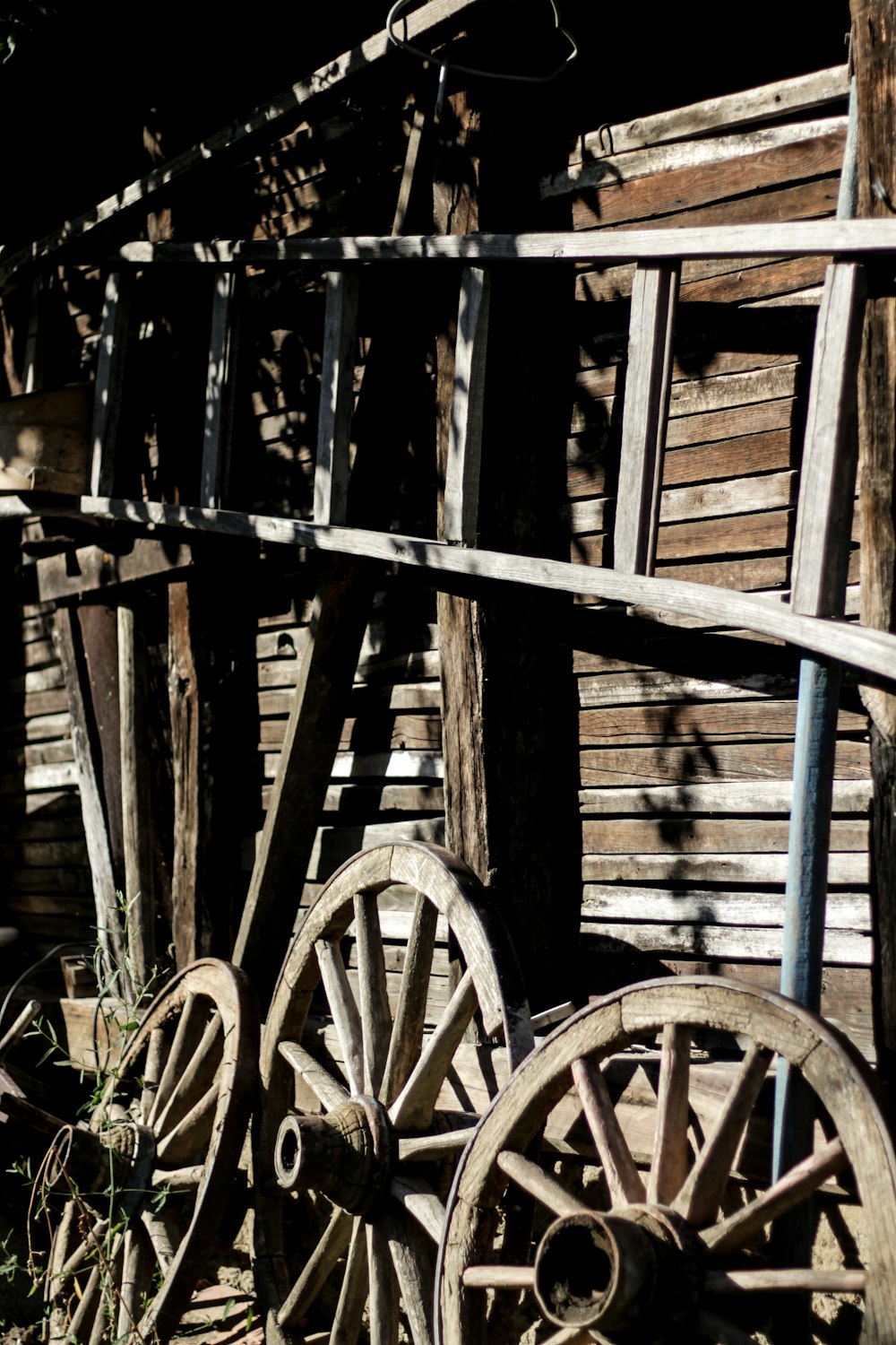 grayscale photography of wheels near wall