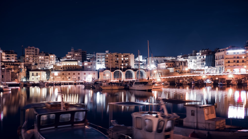 body of water near buildings at night