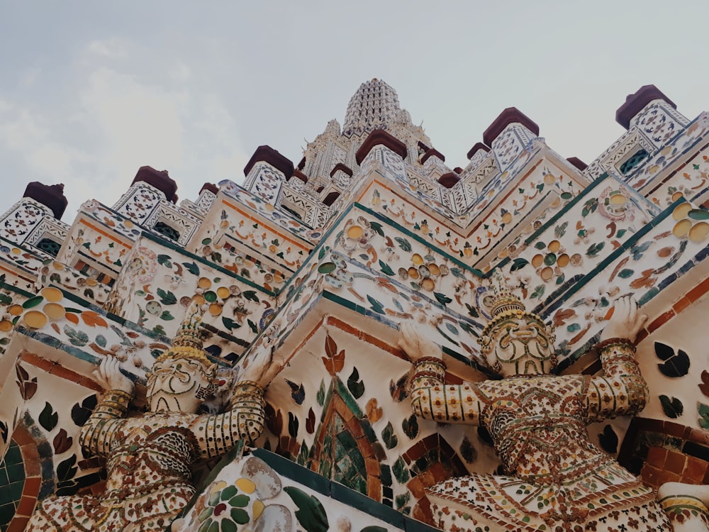 a close up of a building with a statue on top of it