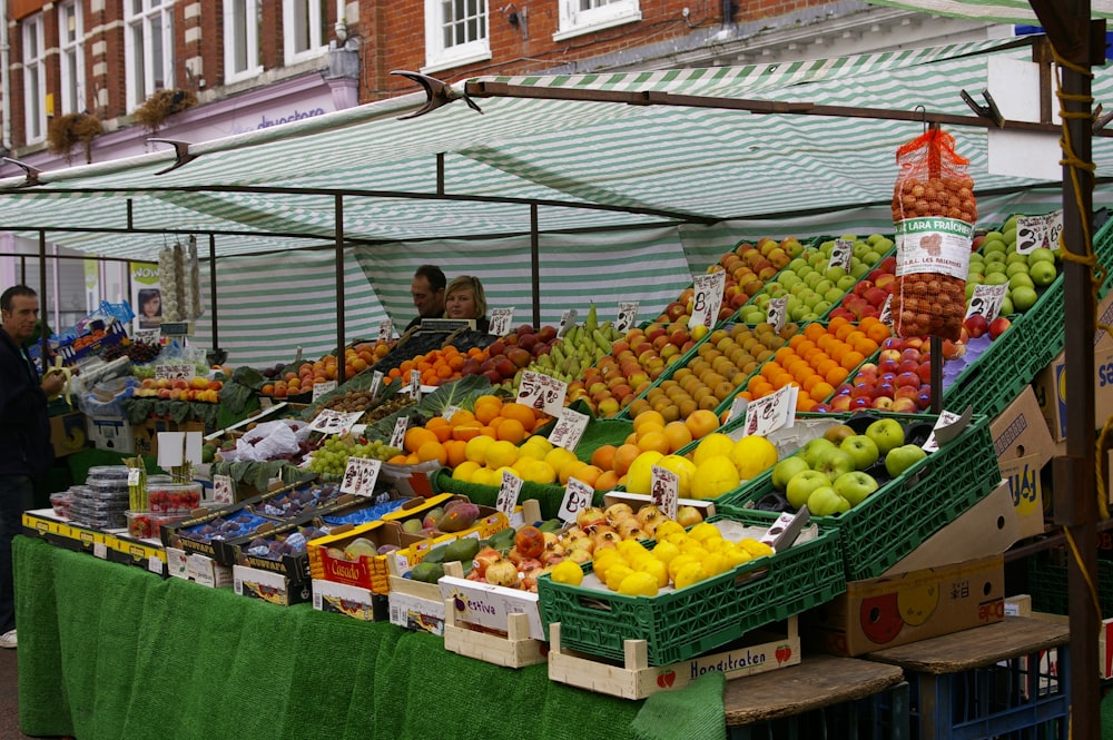 a fruit stand with a variety of fruits on display