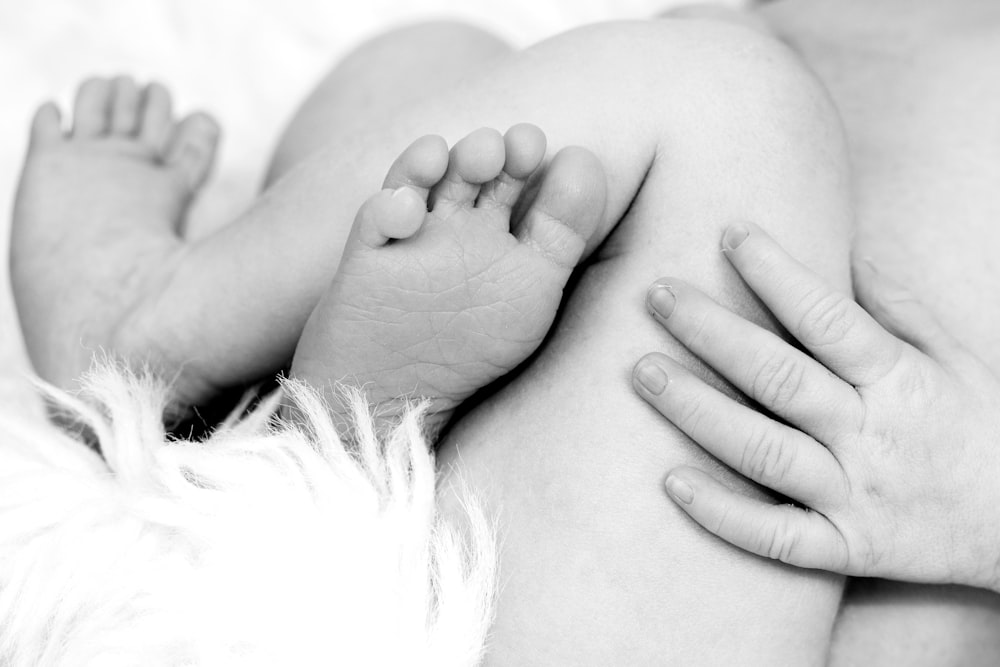 a black and white photo of a baby's feet