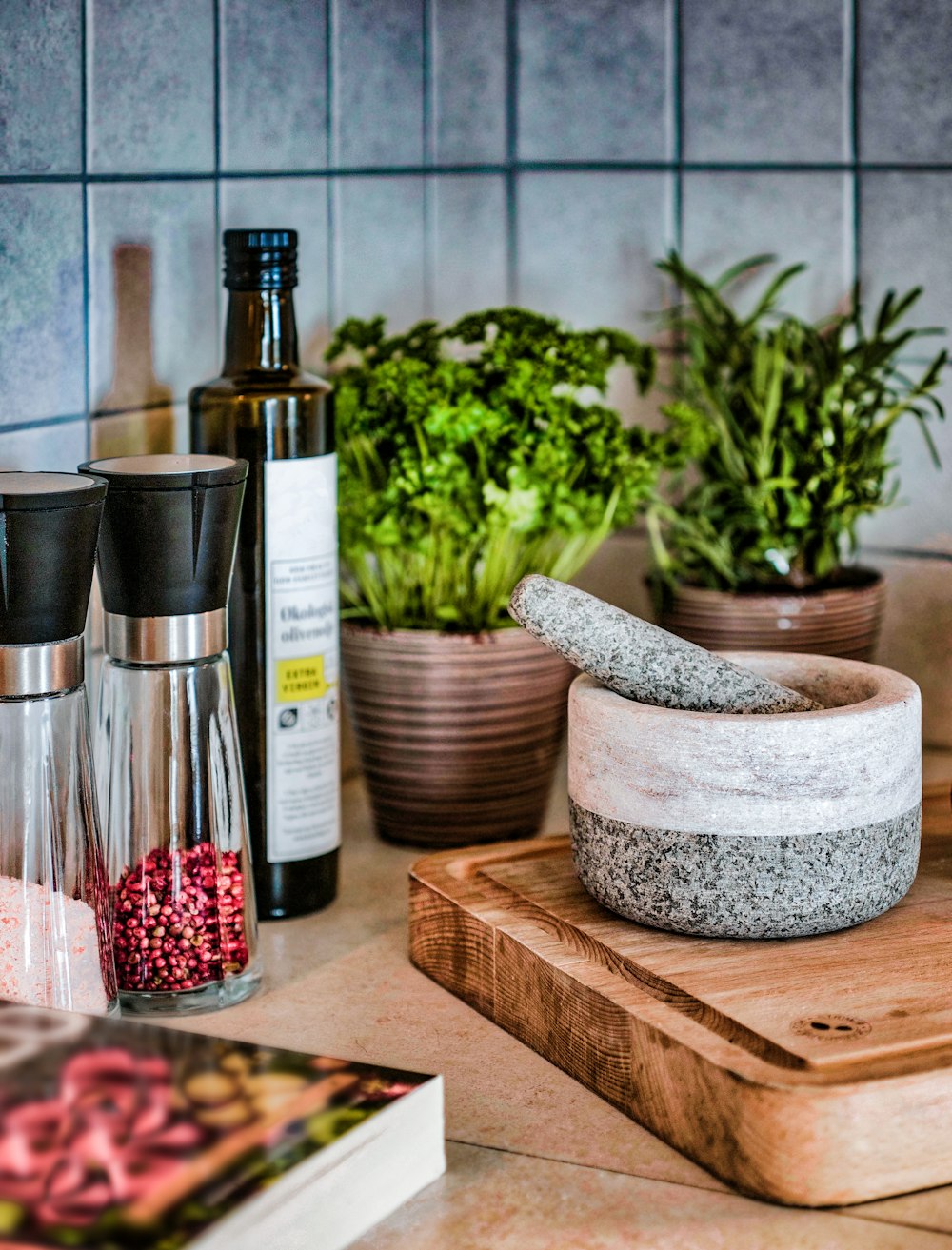 gray mortar and pestle on chopping board near different spices on bottle