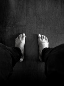 grayscale photography of person wearing pants