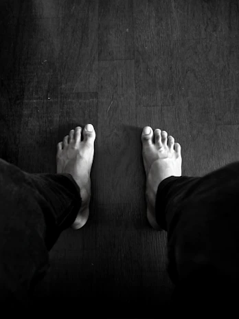 grayscale photography of person wearing pants