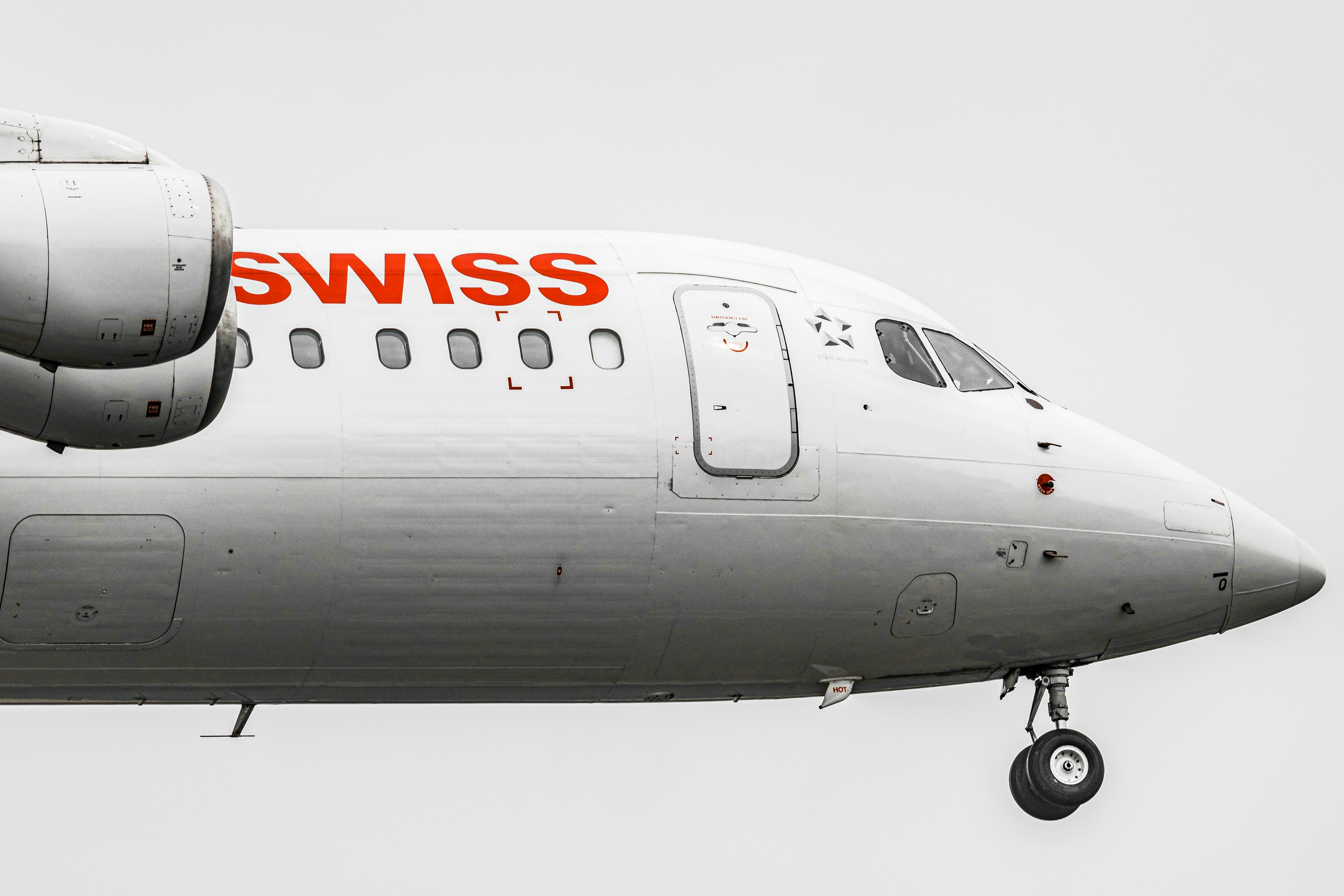 white Swiss airplane, Jet landing - British Aerospace BAe 146 "Jumbolino" of Swiss International Airlines.