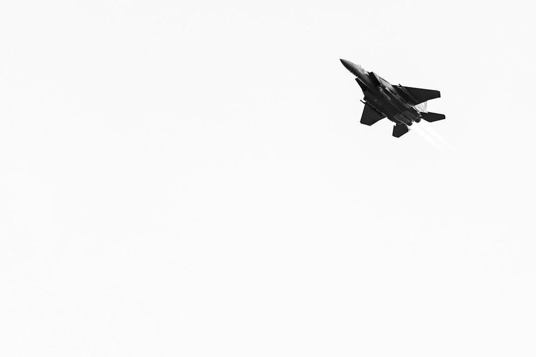 fighter plane under white sky