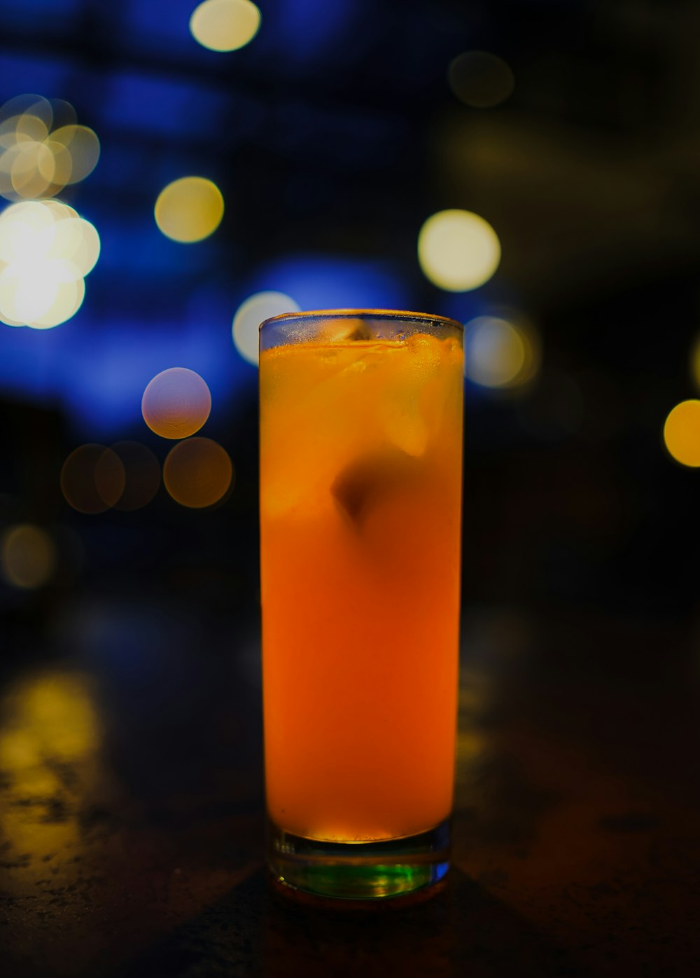 clear drinking glass with orange liquid