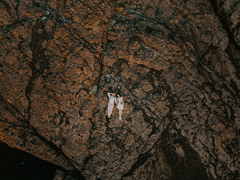 couple lying on rock in aerial photography
