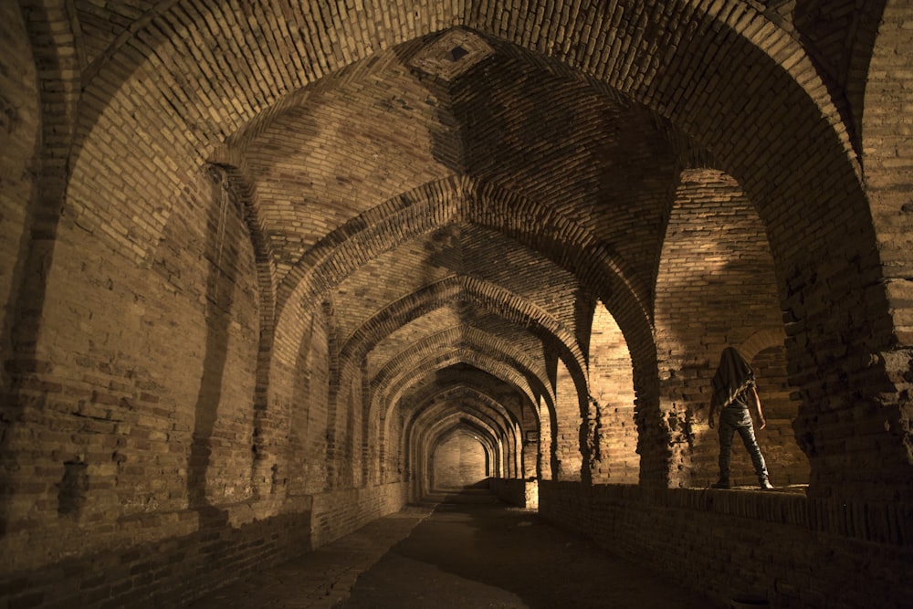 man standing in ancient ruin structure