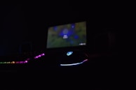 Stream-ready setup showing a tan-colored mechanical keyboard, gaming mouse, and a sleek webcam, no people present.