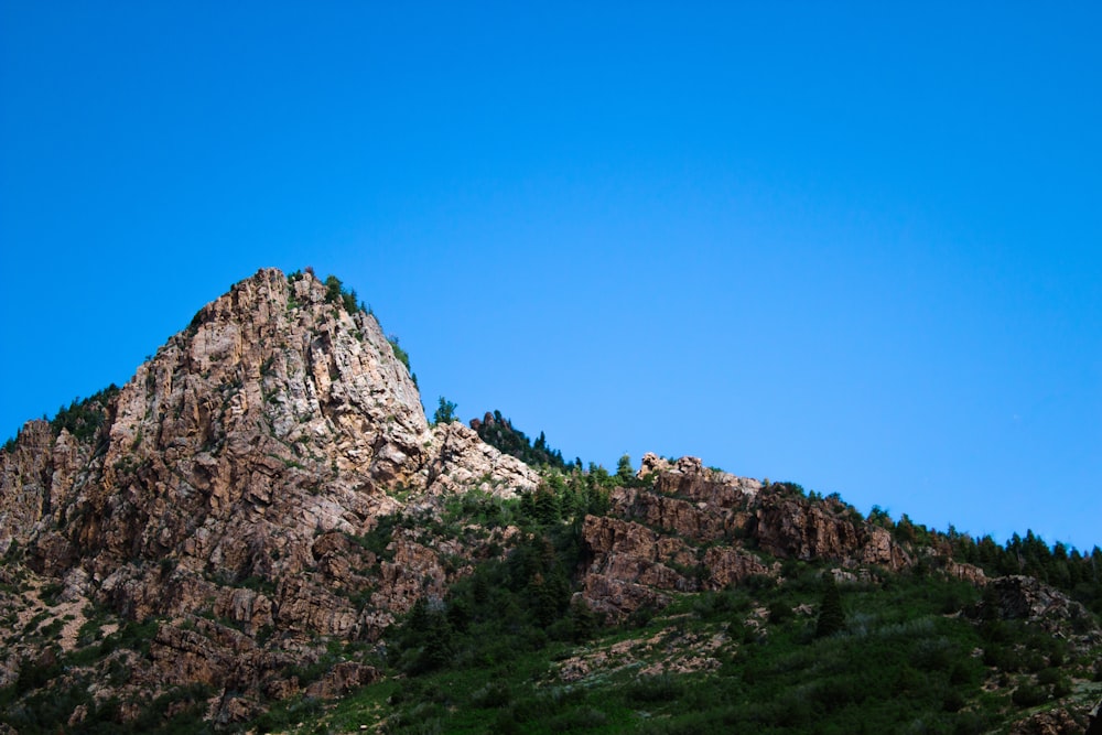 rocky cliff under blue sky