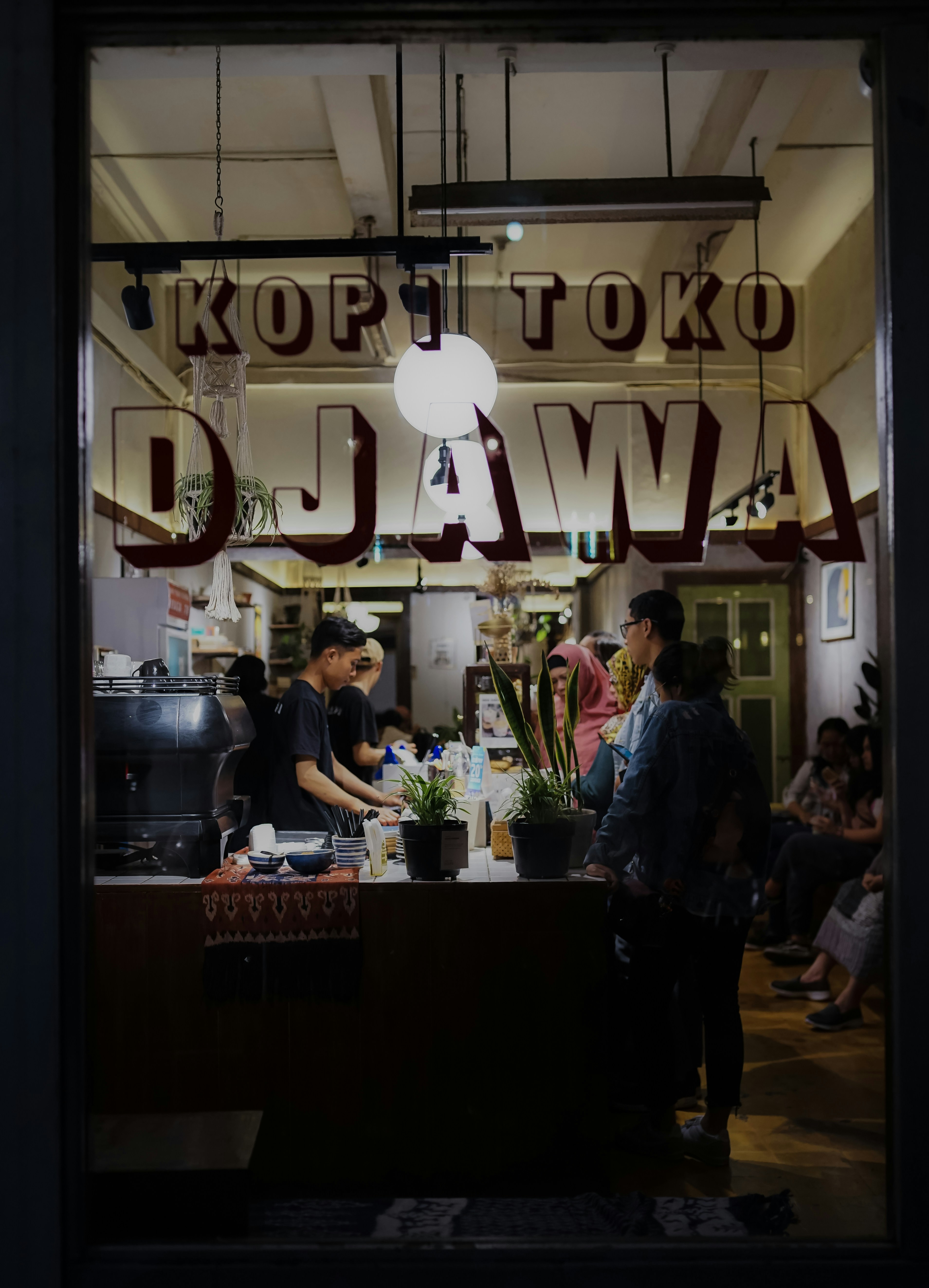 people standing inside Kopi Toko DJawa building