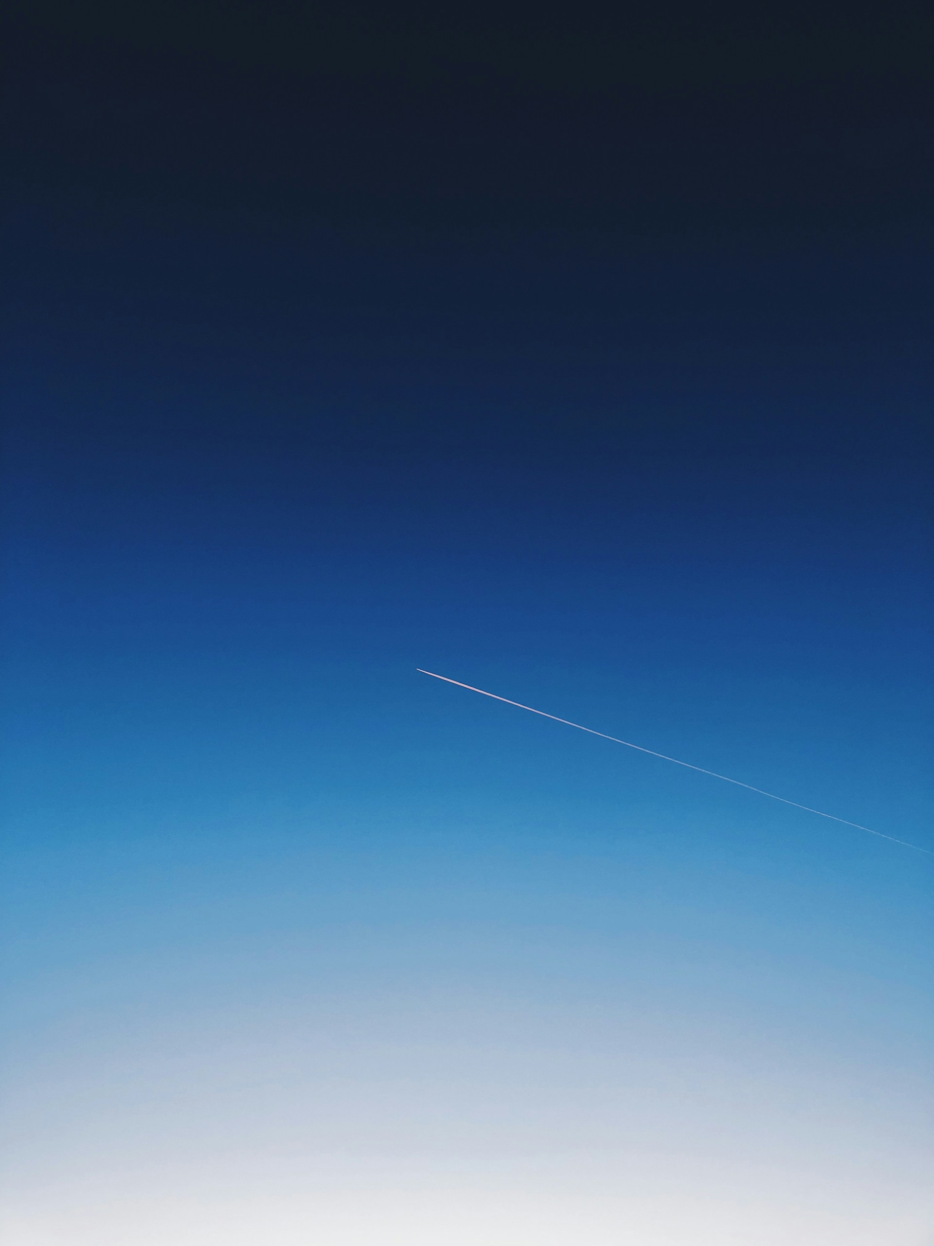 white smoke trail in the sky