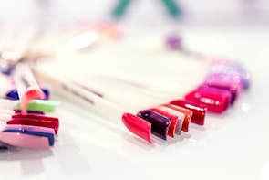 A close-up of a manicure station with colorful nail polishes.