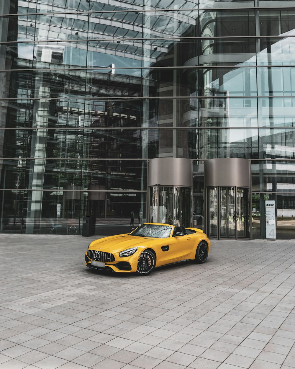 yellow convertible coupe near building